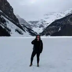 Carly Fielding, Marketing Assistant, standing on a frozen Lake Louise in Canada
